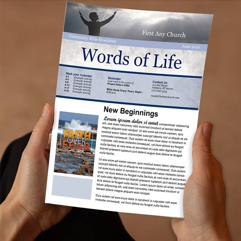 A photo of a person's hands holding a church newsletter in their hands